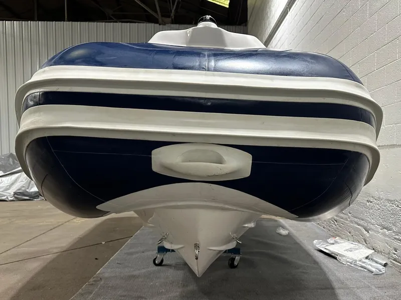 Slide: The Image of 2024 Apex A-18 Deluxe Tender, blue and white, in a warehouse setting. - 8