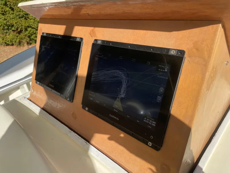 Slide: The Image of Custom Carolina Bandy 26' 2000 boat with dual Garmin navigation screens. - 11
