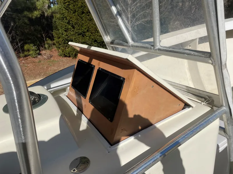 Slide: The Image of Custom Carolina Bandy 26' 2000 boat dashboard with dual screens and compass. - 13