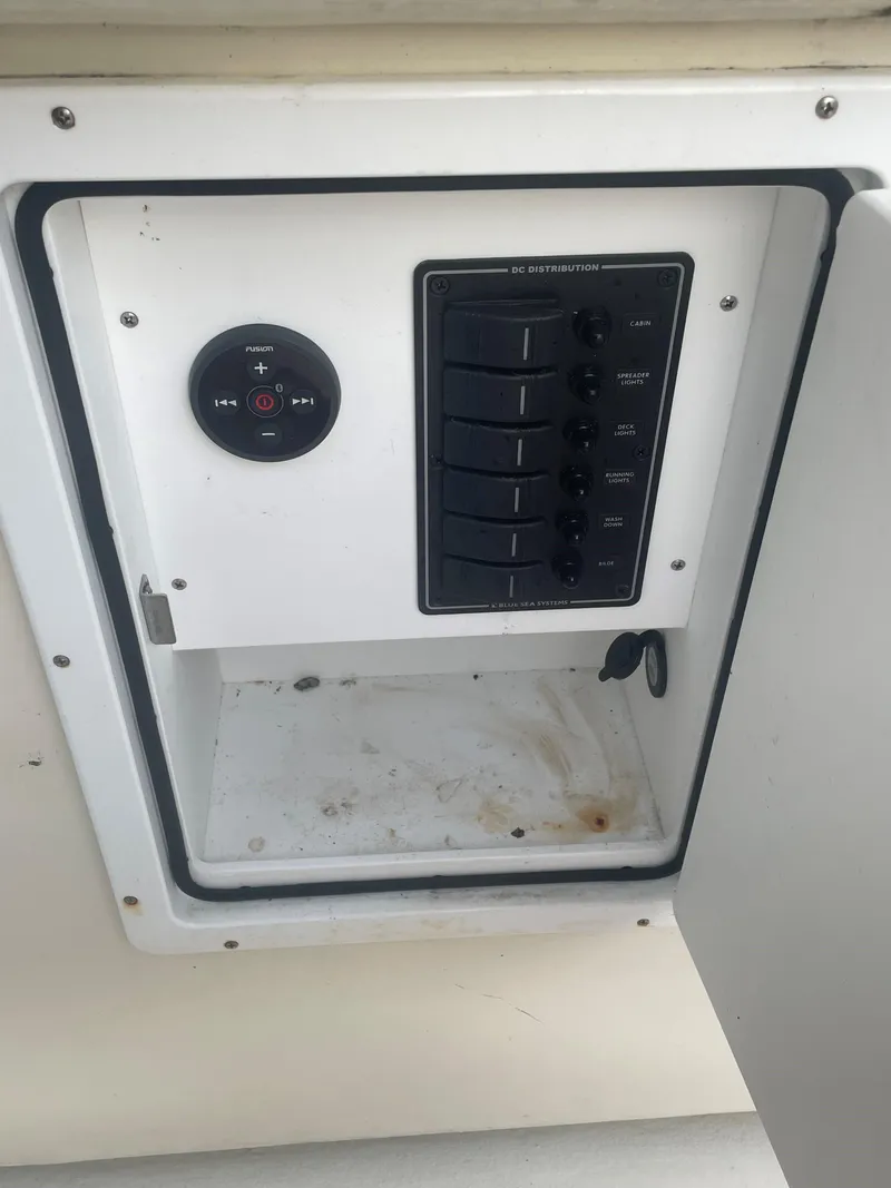 Slide: The Image of Electrical panel inside Custom Carolina Bandy 26', 2000 model, featuring audio controls and switches. - 23