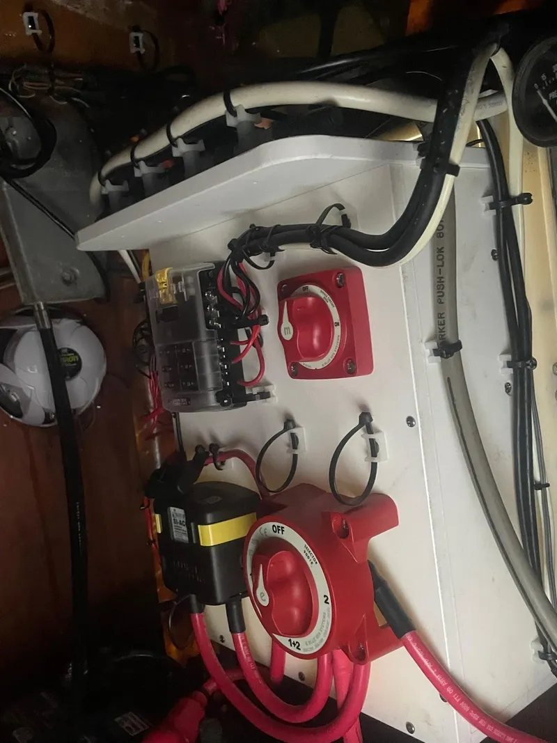 Slide: The Image of Electrical panel of 2000 Custom Carolina Bandy 26' boat with wiring and switches. - 24