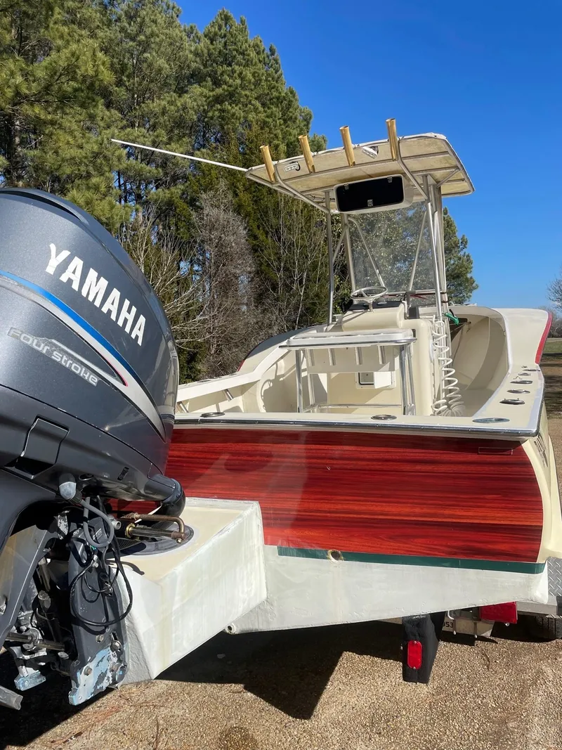 Slide: The Image of Custom Carolina Bandy 26' boat with Yamaha engine, 2000 model, parked outdoors. - 4