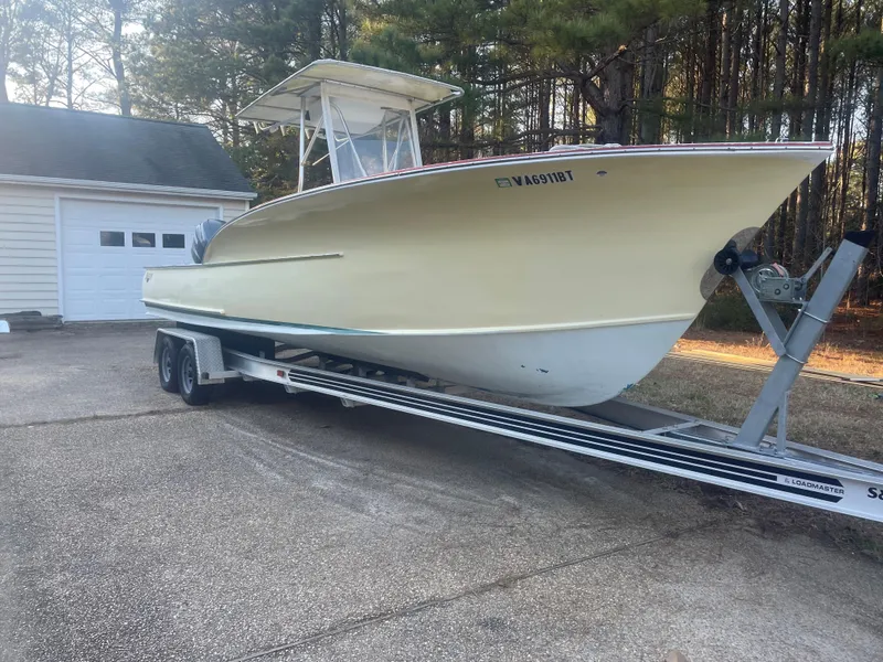 Slide: The Image of Custom Carolina Bandy 26' boat on trailer, parked near garage, 2000 model. - 5