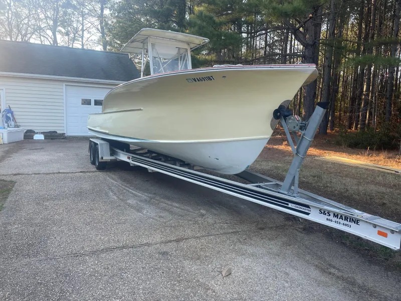Slide: The Image of Custom Carolina Bandy 26' boat on trailer, 2000 model, parked near garage. - 6