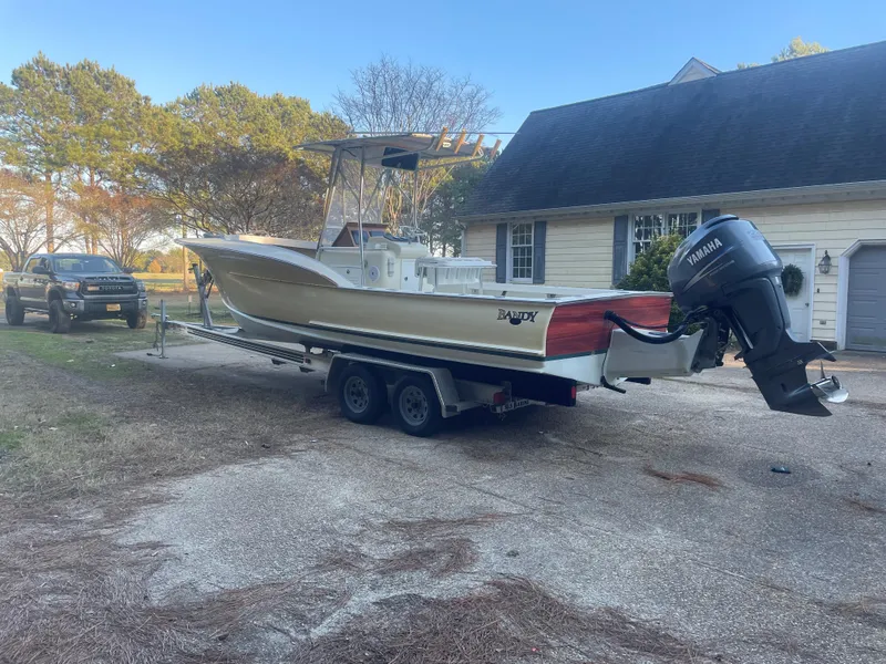 Slide: The Image of Custom Carolina Bandy 26' boat on trailer, Yamaha outboard, parked near house, 2000 model. - 8