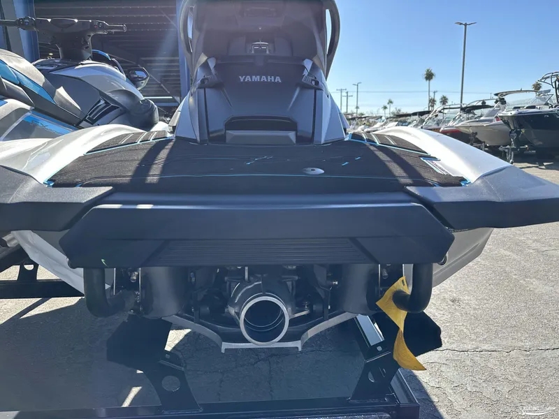 Slide: The Image of 2024 Yamaha WaveRunner FX Cruiser HO w/Audio, rear view in a sunny outdoor setting. - 7