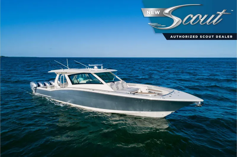 The Image of 2025 Scout 530 LXF luxury boat cruising on open water under clear blue skies. - 0
