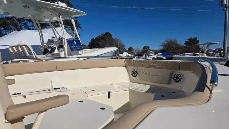 Slide: The Image of 2024 Scout 240 XSF boat interior with beige seating and modern design. - 10