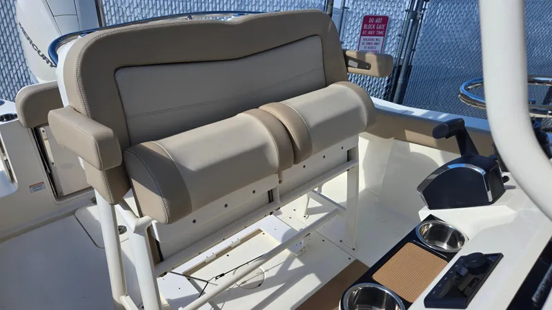 Slide: The Image of 2024 Scout 240 XSF boat interior with beige seating and control panel. - 13