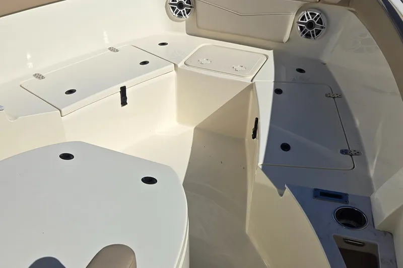 Slide: The Image of 2024 Scout 240 XSF boat interior with storage compartments and speakers. - 15
