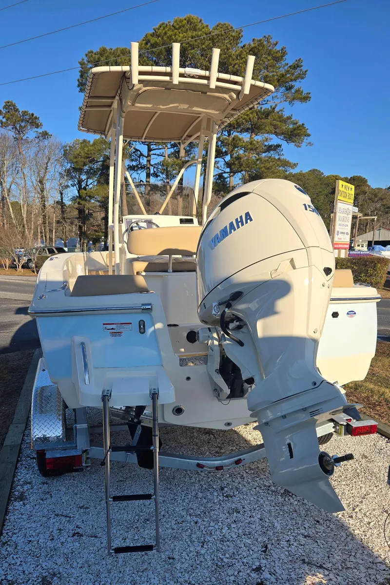 Slide: The Image of 2025 Scout 195 Sportfish boat with Yamaha outboard motor, parked on a trailer. - 12