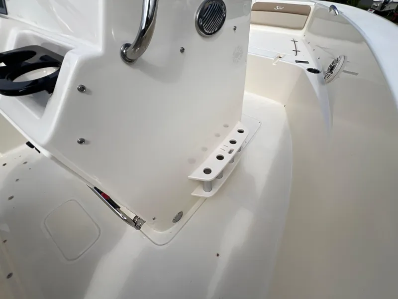 Slide: The Image of 2025 Scout 195 Sportfish boat interior with rod holders and steering console. - 7