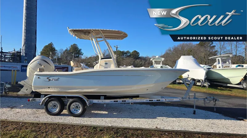 The Image of 2025 Scout 195 Sportfish boat on trailer at authorized dealer, side view. - 0