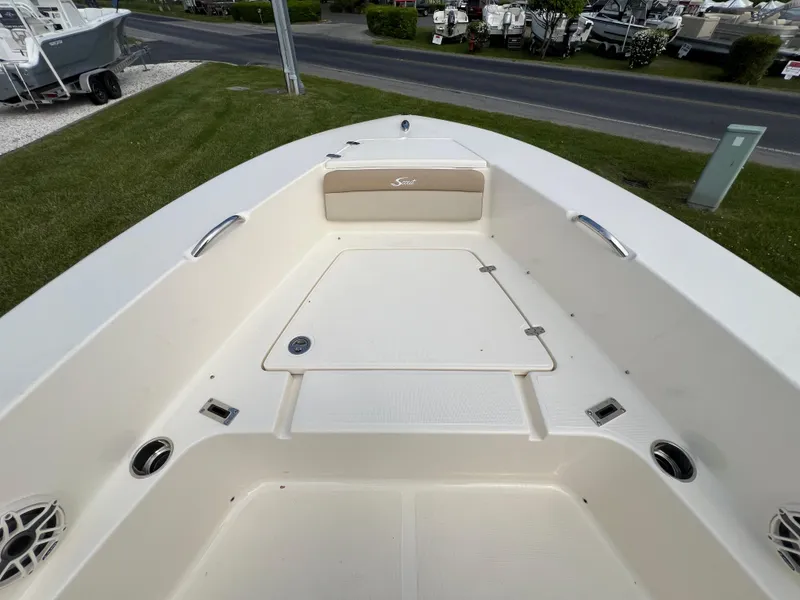 Slide: The Image of 2025 Scout 195 Sportfish boat deck with storage compartments and seating. - 4