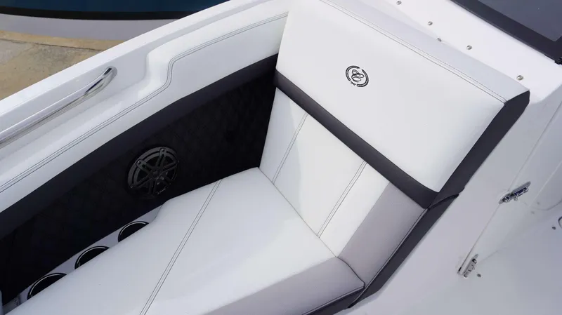 Slide: The Image of 2024 Cobalt R4 boat interior with white and black cushioned seating. - 12