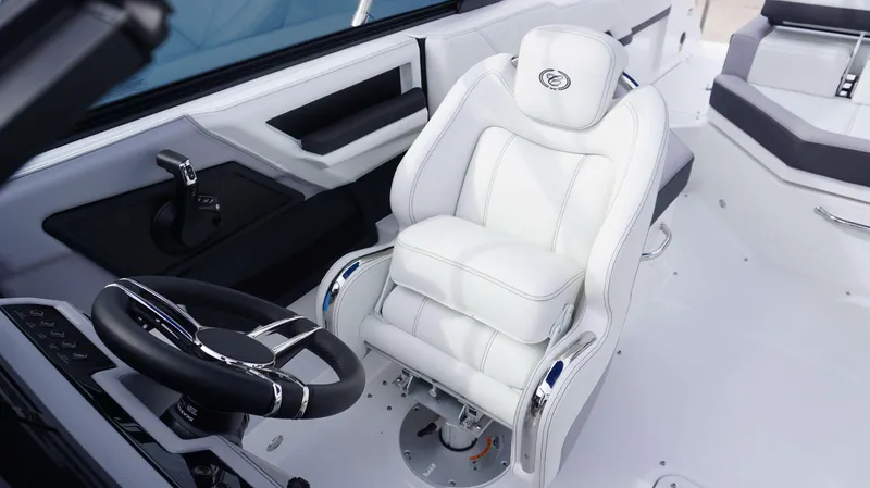 Slide: The Image of 2024 Cobalt R4 boat interior with white captain's chair and black steering wheel. - 13