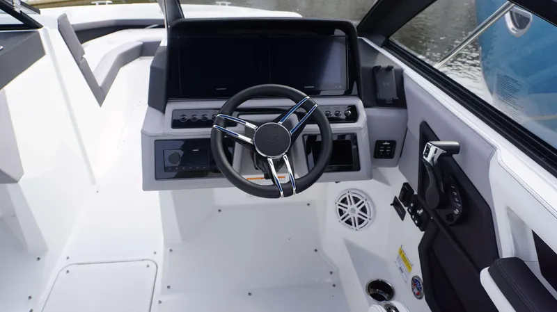 Slide: The Image of 2024 Cobalt R4 boat cockpit with modern steering wheel and dual display screens. - 3
