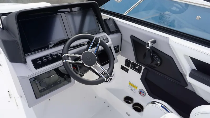 Slide: The Image of 2024 Cobalt R4 boat dashboard with dual Garmin screens and modern steering wheel. - 5