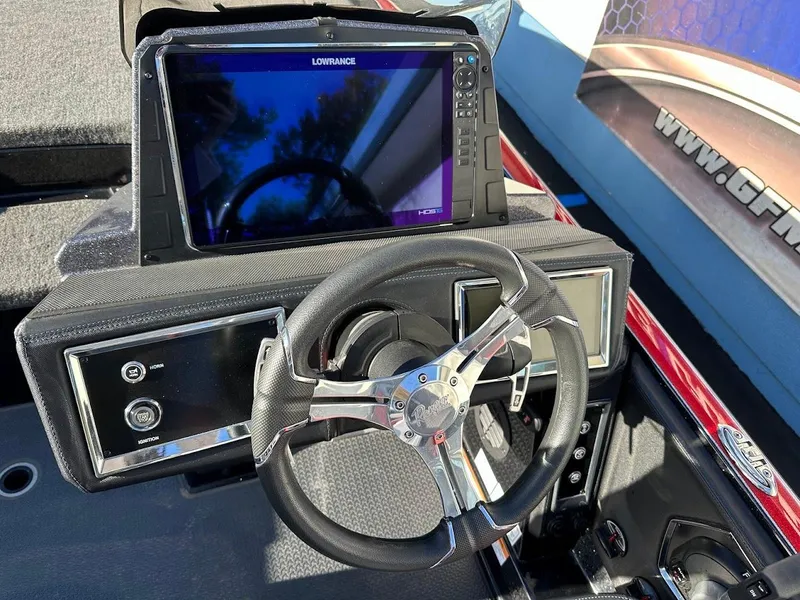Slide: The Image of 2024 Ranger Z521R boat dashboard with steering wheel and Lowrance display. - 14