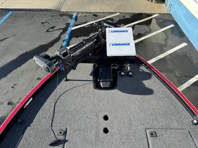 Slide: The Image of 2024 Ranger Z521R boat deck with Lowrance equipment, parked on asphalt. - 17