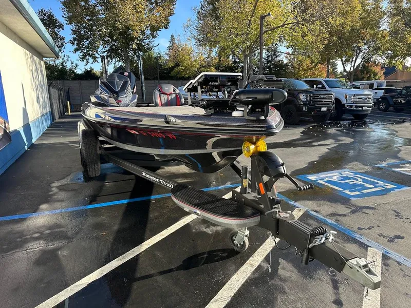 Slide: The Image of 2024 Ranger Z521R Ranger Cup Equipped boat on trailer in parking lot. - 2