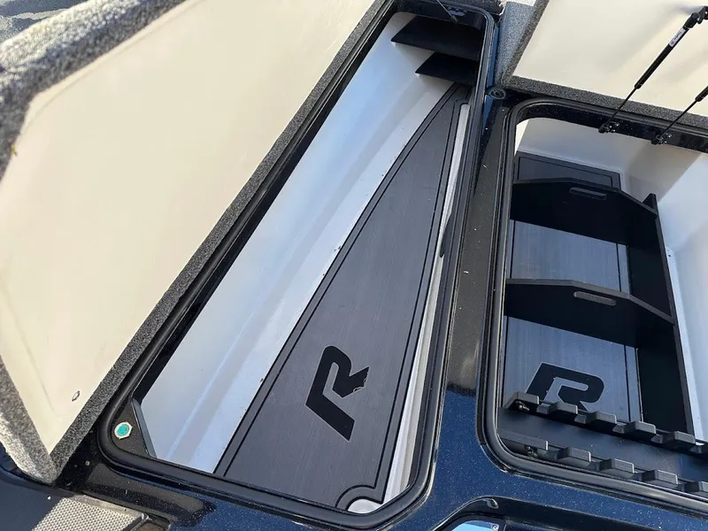 Slide: The Image of 2024 Ranger Z521R storage compartments with sleek design and logo detailing. - 22