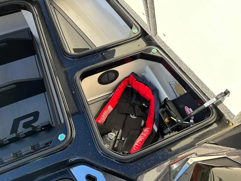 Slide: The Image of Open storage compartment in 2024 Ranger Z521R boat with life jacket and equipment. - 24