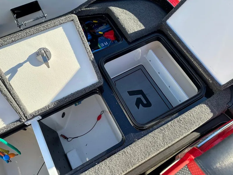 Slide: The Image of 2024 Ranger Z521R storage compartments with open lids, showcasing organized interior space. - 29