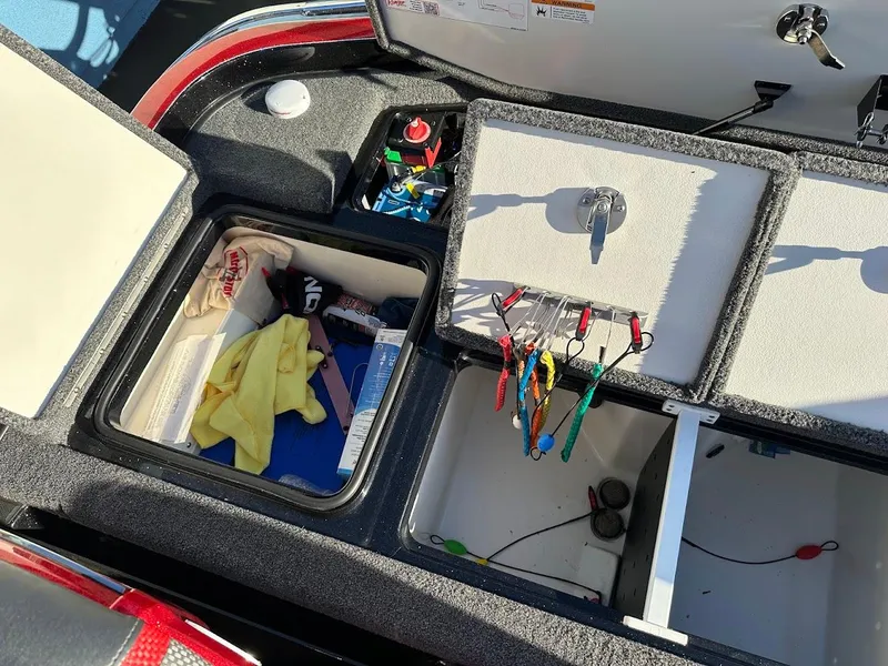 Slide: The Image of 2024 Ranger Z521R boat storage compartments with fishing gear and accessories. - 30