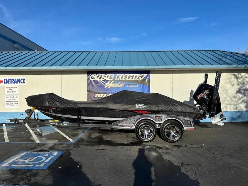 Slide: The Image of 2024 Ranger Z521R boat covered, parked outside a building under a clear blue sky. - 35