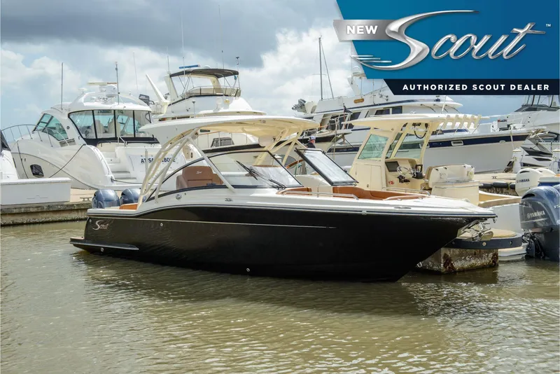 The Image of 2025 Scout 255 Dorado boat docked at marina, authorized dealer signage visible. - 0