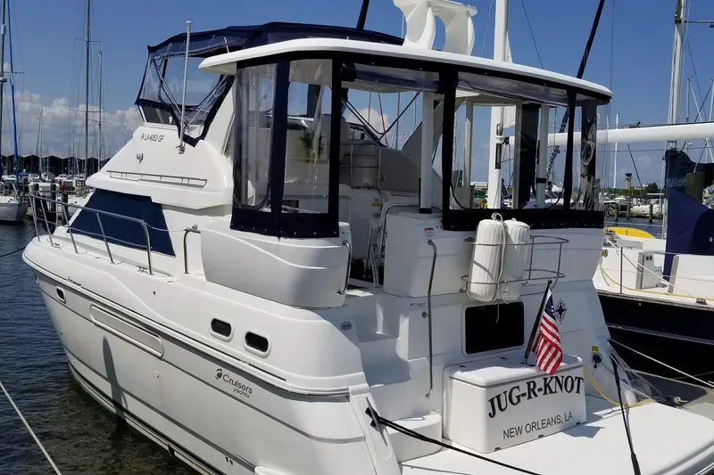 The Image of 2001 Cruisers 3750 yacht docked, featuring a white exterior and American flag. - 0