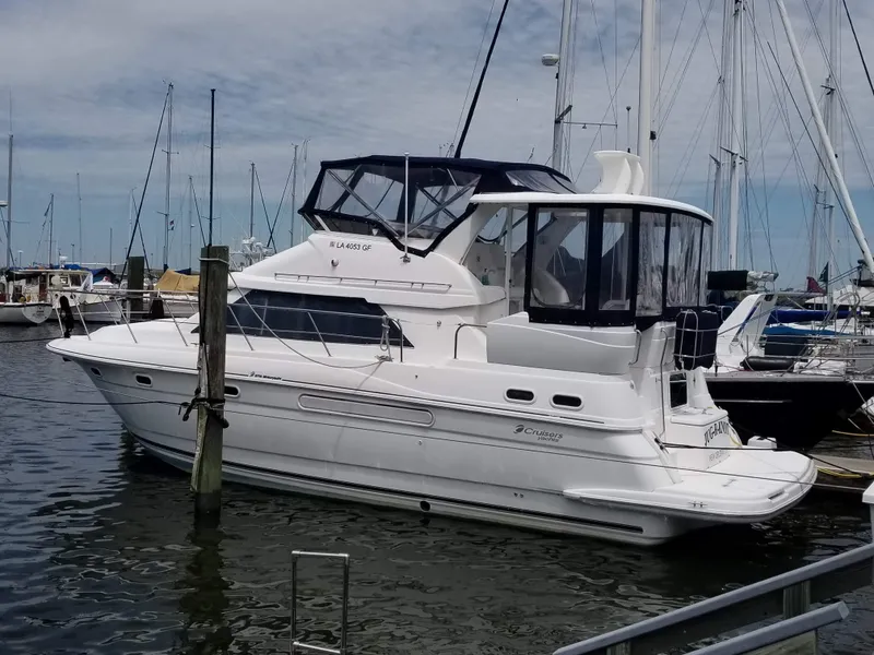 Slide: The Image of 2001 Cruisers 3750 yacht docked at a marina with clear skies. - 1