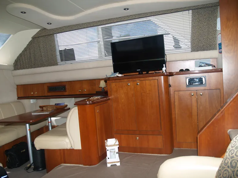 Slide: The Image of Interior of 2001 Cruisers 3750 yacht with wood cabinetry and seating area. - 11
