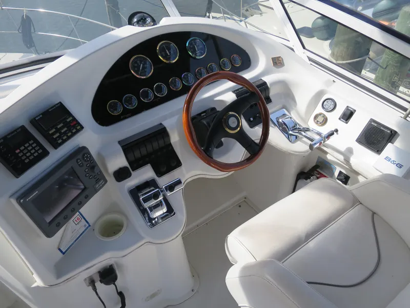 Slide: The Image of 2001 Cruisers 3750 yacht helm with gauges, controls, and white seating. - 5