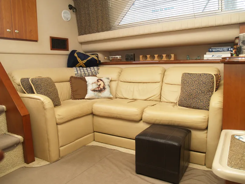 Slide: The Image of Luxurious interior of 2001 Cruisers 3750 yacht with beige leather seating and decorative pillows. - 14