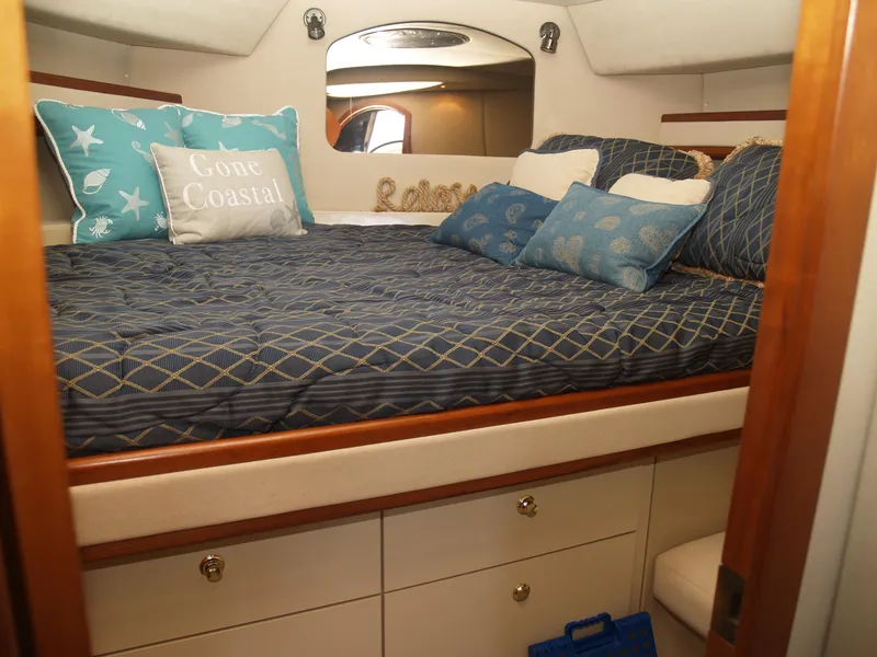 Slide: The Image of 2001 Cruisers 3750 yacht cabin with cozy bedding and decorative pillows. - 15