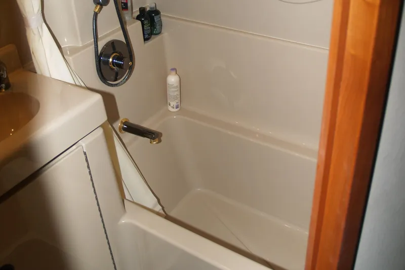 Slide: The Image of Bathroom interior of 2001 Cruisers 3750 yacht, featuring a compact shower area. - 18