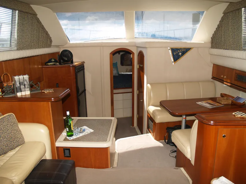 Slide: The Image of Interior of a 2001 Cruisers 3750 yacht with elegant wood and leather furnishings. - 8