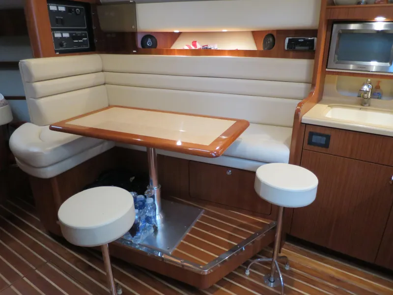 Slide: The Image of 2004 Tiara Yachts 3800 Open interior with dining area and kitchenette. - 11