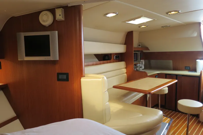 Slide: The Image of Luxurious interior of 2004 Tiara Yachts 3800 Open, featuring a cozy dining area and modern amenities. - 13