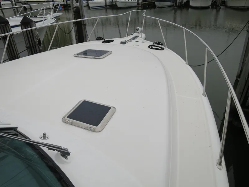 Slide: The Image of 2004 Tiara Yachts 3800 Open bow deck at marina. - 2