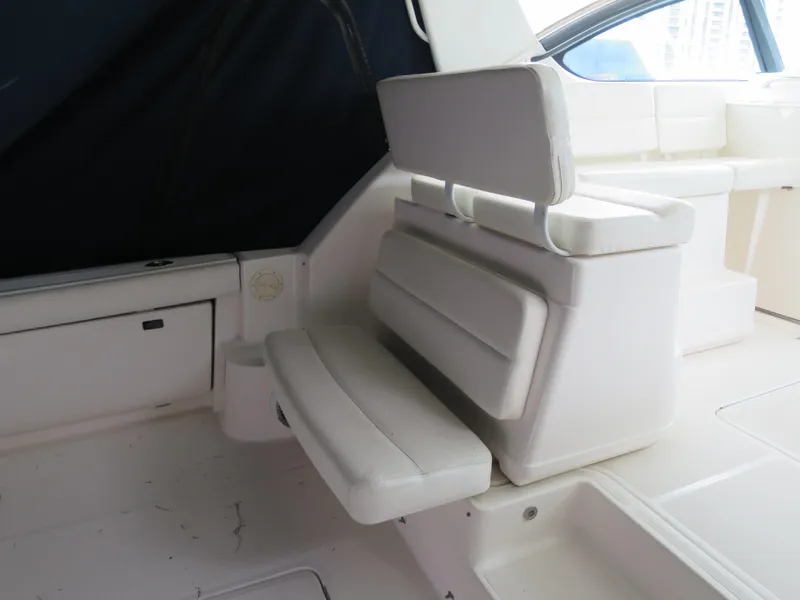Slide: The Image of 2004 Tiara Yachts 3800 Open interior seating area with white cushioned seats. - 5