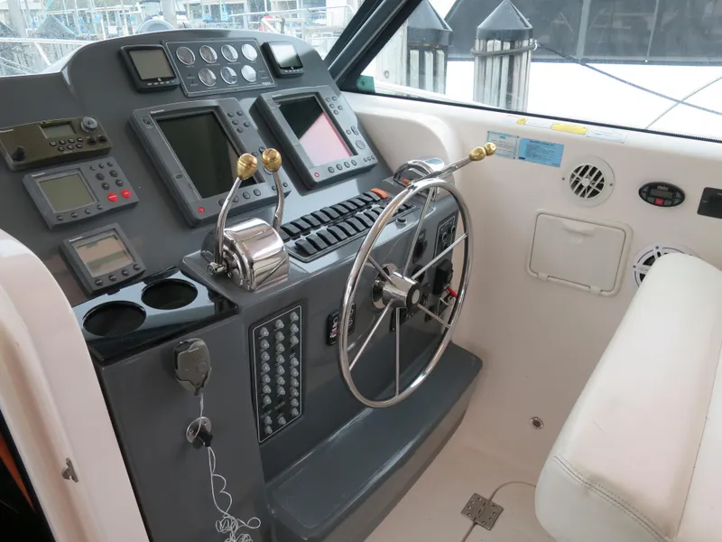 Slide: The Image of 2004 Tiara Yachts 3800 Open helm station with navigation equipment and steering wheel. - 6