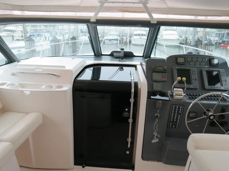 Slide: The Image of 2004 Tiara Yachts 3800 Open helm station with navigation equipment and seating. - 7