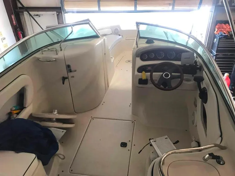 Slide: The Image of Interior of a 2004 Sea Ray 240 Sundeck boat, featuring steering wheel and seating area. - 13