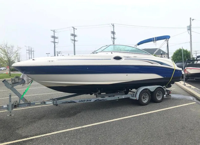 Slide: The Image of 2004 Sea Ray 240 Sundeck boat on trailer, parked in a lot. - 7