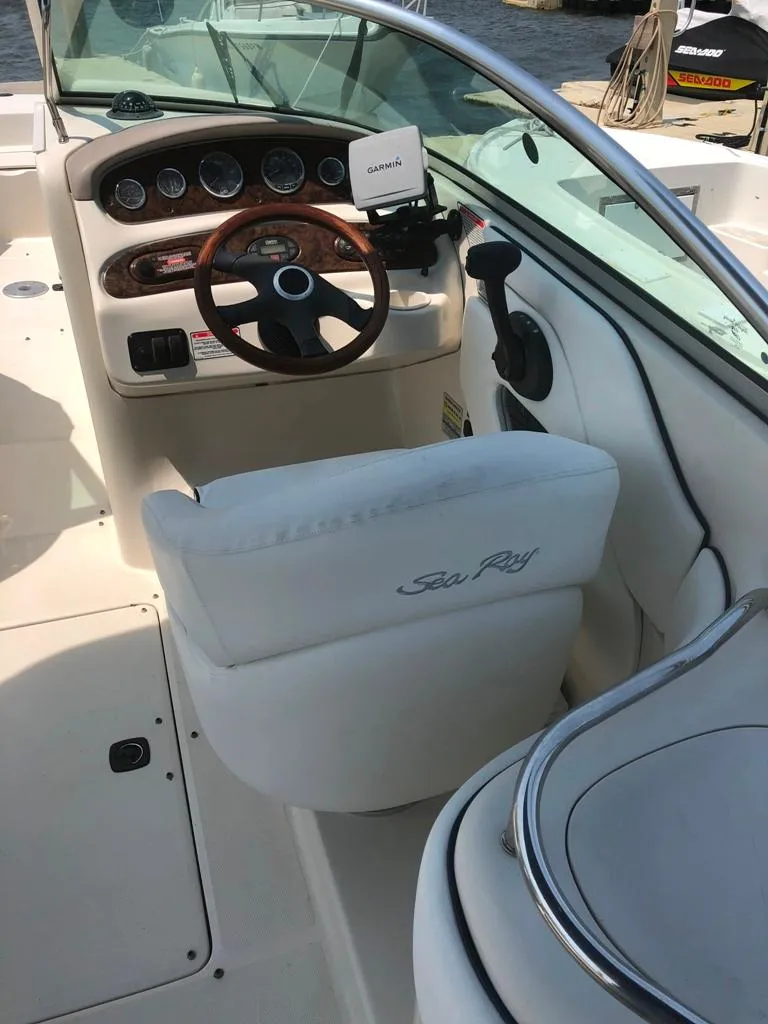 Slide: The Image of 2004 Sea Ray 240 Sundeck boat interior with steering wheel and dashboard. - 9
