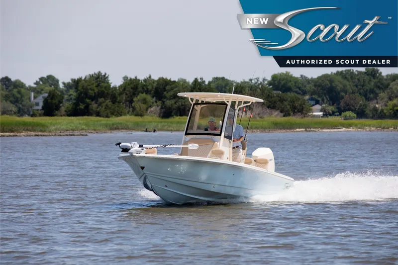 The Image of 2025 Scout 231 XSB boat cruising on a serene lake with lush greenery in the background. - 0