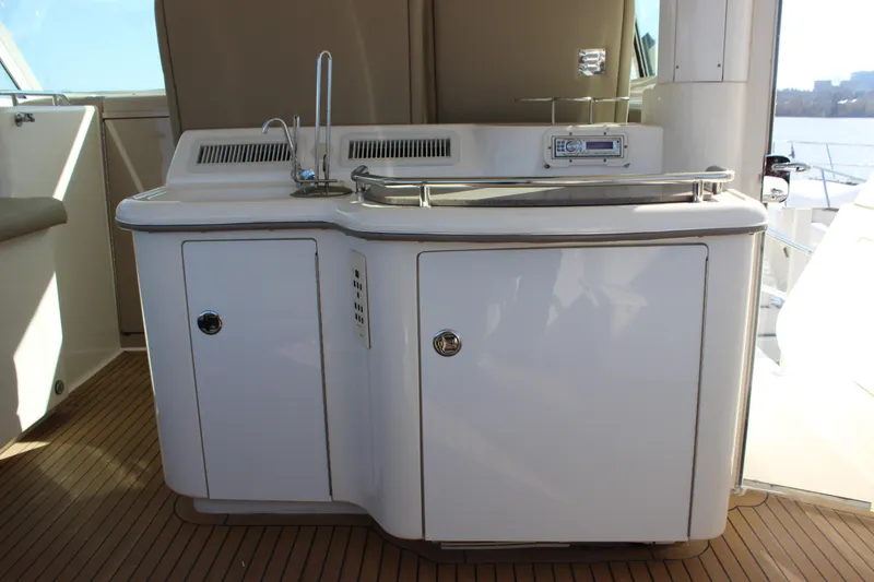 Slide: The Image of 2002 Sea Ray 480 Motor Yacht outdoor kitchenette with sink and storage. - 13